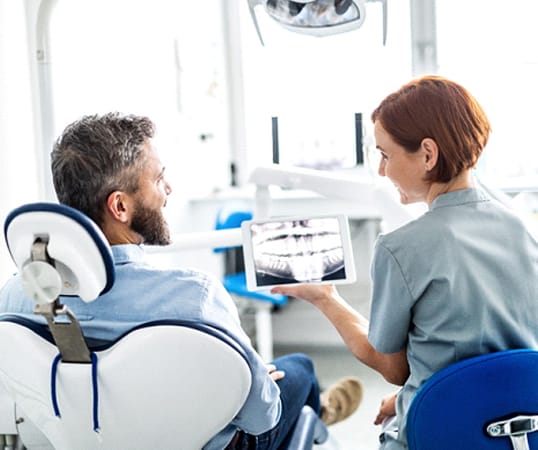 Mesquite implant dentist and patient discussing dental implants