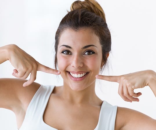 Woman with Lumineers pointing to her smile