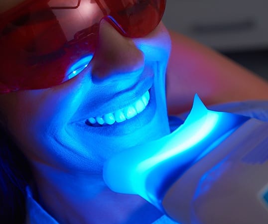 Patient receiving in office teeth whitening