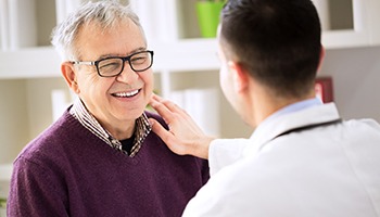 Man with dentures in Mesquite smiling at his Mesquite dentist 