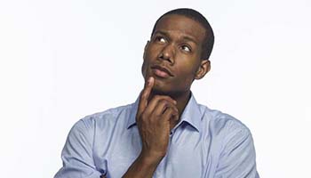 Man touching his chin while looking upwards