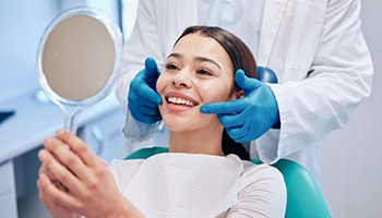 A woman receiving a dental checkup from her dentist 