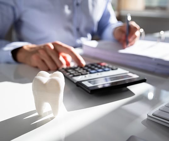 Patient calculating the cost of dental treatment