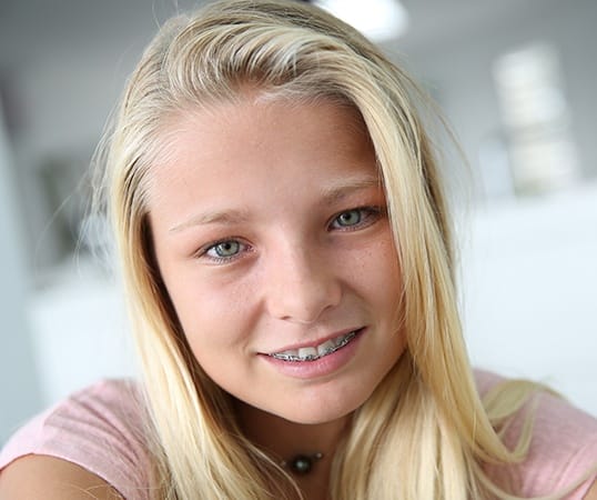 Teen girl with traditional metal braces