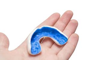 person holding mouthguard