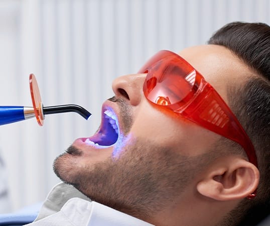 Man receiving dental sealant treatment