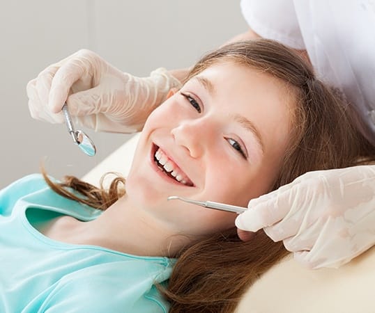 Young girl smiling during children's dentistry visit