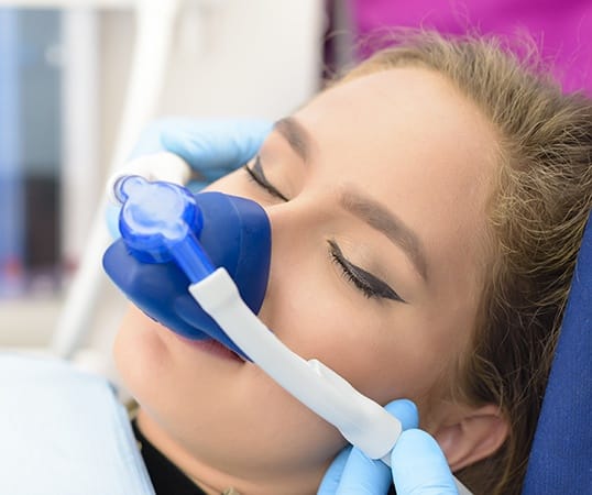 Woman with nitrous oxide sedation dentistry mask in place