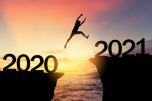 Silhouetted man jumping from cliffs marked 2020 and 2021