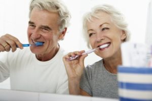 older couple brushing their dental implants in Mesquite