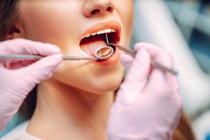 patient getting checked for cavities between teeth in Mesquite