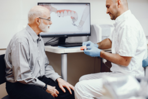 a patient receiving dentures from their dentist